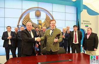 Anatoly Karibov signs two agreements